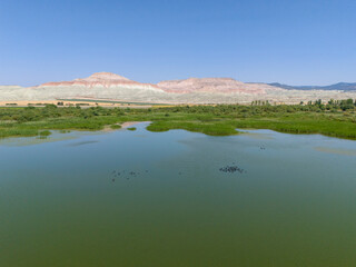 Nallihan Bird Sanctuary Beypazari Ankara Turkey Panoramic view of a serene lake nestled between hills. A breathtaking panoramic shot of a tranquil lake surrounded by rolling hills.Nallıhan Kus Cenneti