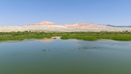 Nallihan Bird Sanctuary Beypazari Ankara Serene lake landscape with colorful mountains reflecting on the water. A tranquil view of a lake, mirroring the vibrant hues of the surrounding mountains.