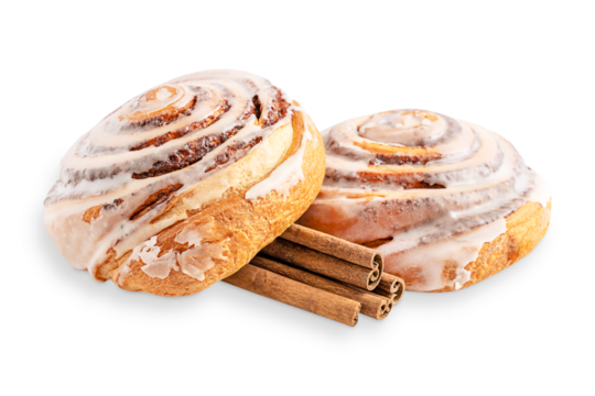 Close up view of two delicious sweet homemade cinnamon rolls bun or swirl dessert glazed with sugar icing with spice sticks isolated on white background served for morning breakfast as baked pastry 