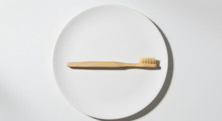 Wooden spoon placed diagonally on white round plate in top view with soft shadows for culinary minimalism