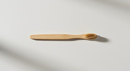 Clean flat lay of wooden spoon on white background with long soft shadow, ideal for culinary branding or design