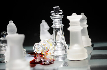 Glass chess pieces on a board symbolize a corporate or political power struggle. Dramatic defeat, betrayal, or leadership failure.