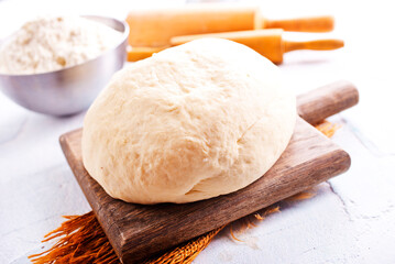Photo of yeast puff pastry. Photo from above on the background of a wooden board.