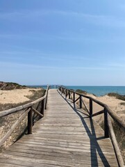 Fototapeta premium Coastal boardwalk to the beach on a sunny day