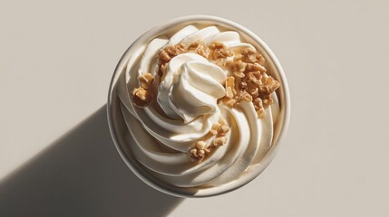 Minimalist frozen yogurt swirl in ceramic cup, flat lay with crumbled nuts and smooth shadows