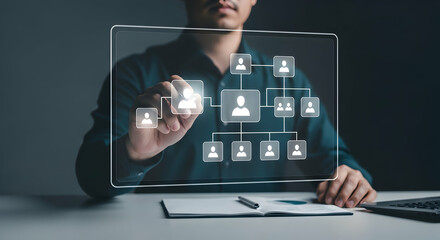 A person interacts with a transparent screen displaying a network organizational chart