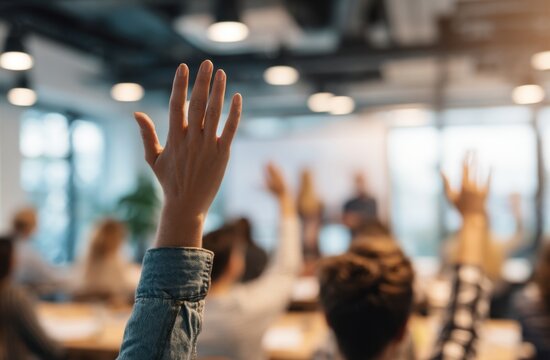 A hand reaches up, a moment of shared curiosity and engagement in a modern workshop setting.