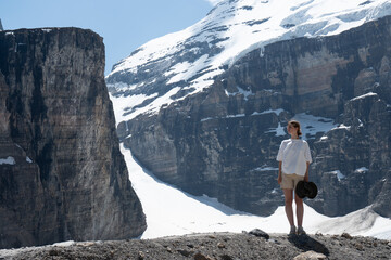 Woman stands on mountain ridge