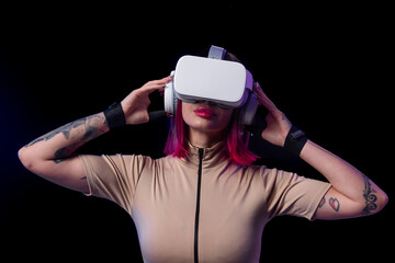Woman adjusting VR headset in futuristic setup