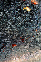 Close up of heavy black rust on a brass base of a kitchen sauce pan abstract background