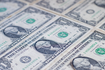 Rows of one-dollar bills arranged in a pattern. 
