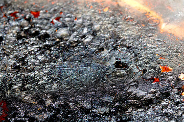 Close up of heavy black rust on a brass base of a kitchen sauce pan abstract background