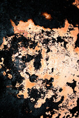 Close up of heavy black rust on a brass base of a kitchen sauce pan abstract background