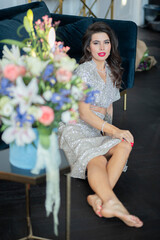 beautiful girl in a shiny dress with flowers