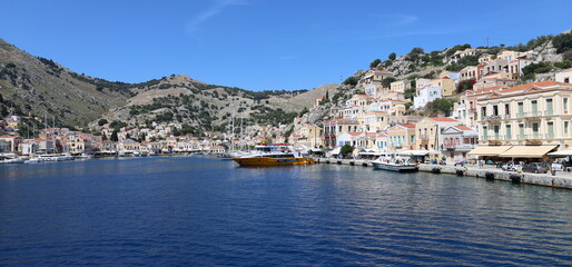 Seaside Greek Village – Symi Island Harbor with Boats and Hillside Homes