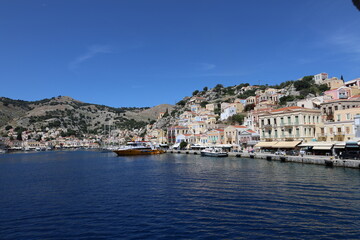Seaside Greek Village &ndash; Symi Island Harbor with Boats and Hillside Homes
