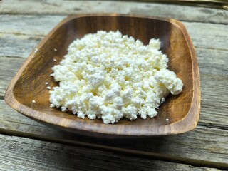 Homemade traditional cottage cheese organic dairy product in wooden bowl