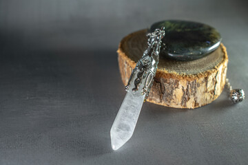 A powerful clear crystal quartz pendulum and a mesmerizing labradorite stone, embodying spiritual...