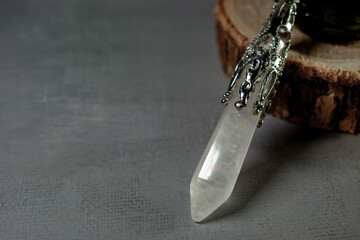 A powerful clear crystal quartz pendulum and a mesmerizing labradorite stone, embodying spiritual...