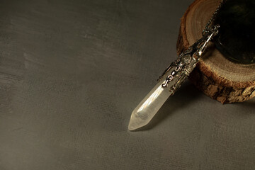 A powerful clear crystal quartz pendulum and a mesmerizing labradorite stone, embodying spiritual...