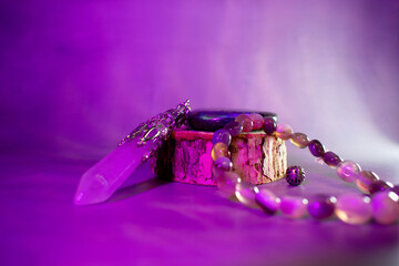 A powerful arrangement of a labradorite stone, crystal quartz pendulum, and agate bracelet,...