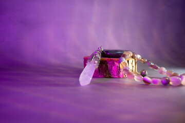 A powerful arrangement of a labradorite stone, crystal quartz pendulum, and agate bracelet, symbolizing balance, healing energy, and spiritual connection. Perfect for mystical and wellness themes.