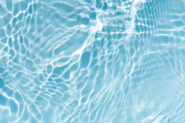 Blue water with ripples on the surface. Defocus blurred transparent blue colored clear calm water...