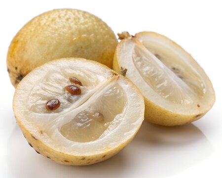 Half cut lanzones fruit showing pulp on white backdrop