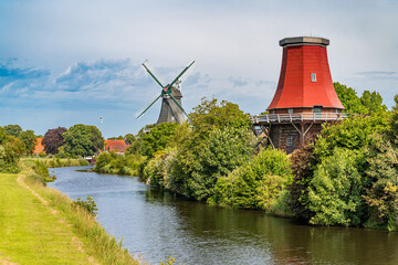 The twin windmills of Greetsiel at the North Sea, East Frisia, Lower Saxony, Germany