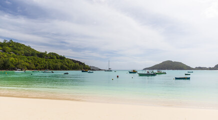Mahe island, Seychelles. Beautiful tropical beach with turquoise waters and boats
