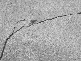 Big winding deep crack on old gray concrete wall. Abstract image of diagonally cleft. Several of...