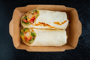 Two tasty burritos filled with fresh ingredients are ready for a satisfying lunch!