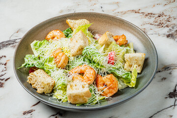 Crisp lettuce mingles with succulent shrimp and croutons, all generously garnished with parmesan