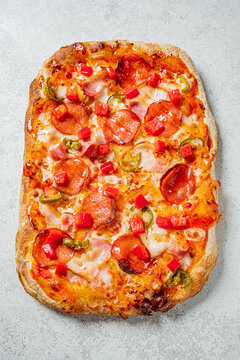 Savory flatbread pizza with pepperoni, green peppers, and vibrant tomatoes ready to be enjoyed