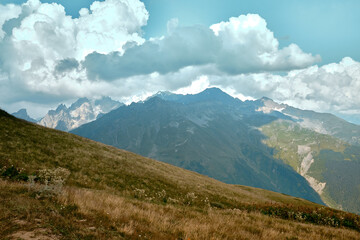 Mountain ranges on a sunny day at Georgia. Sky with clouds adn hills