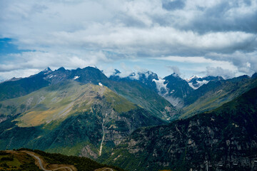 Fototapeta premium Mountain ranges on a sunny day at Georgia. Sky with clouds adn hills