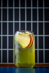 Bright green beverage with crisp apple slices, perfect for a summer refreshment on a warm day
