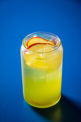 A refreshing citrus drink enhanced with crisp apple slices, perfect for summer