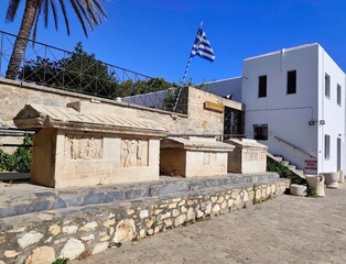 PAROS, GREECE - JUNE 28TH 2025: Exterior view of the Archaeological Museum of Paros in Parikia. It features indoor and outdoor exhibits of ancient artifacts, statues, and sarcophagi.