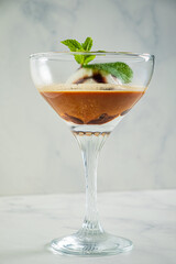 Decadent dessert combines layers of coffee flavors topped with a scoop of ice cream and mint