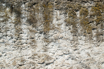 Textured old Mediterranean house wall with grunge aesthetics closeup as stone background