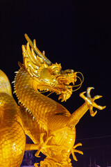 Chinese Golden Dragon in the middle
Of a fountain in Old Phuket Town Thailand At Sunset blue hour....