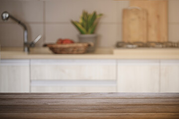 Wooden tabletop on kitchen background with blurred background. Mockup for product demonstration or...