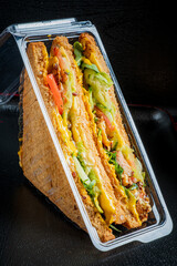 A delicious club sandwich with crispy lettuce, ripe tomato, and layers of cheese awaits!