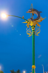Light pole with a dolphin statue at Sunset Blue hour in Patong in the island of phuket Thailand 