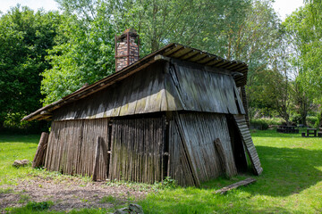 A vintage wooden shed featuring a rustic chimney in france