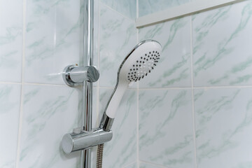 This image reveals a detailed closeup of a shower head installed in a stylish bathroom, showcasing...