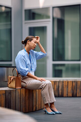Korean businesswoman having headache after stressful day at work.