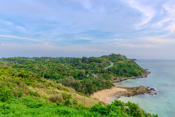 Fototapeta premium Ya Nui Beach in Phuket Thailand, turquoise blue waters, lush green mountains colourful skies. Phuket is a tropical island many palms