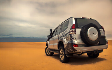 A powerful gray 4x4 SUV stands alone in the vast sandy terrain of the Namib Desert, ready for off-road travel, exploration, and endurance across one of Africa’s wildest landscapes. 